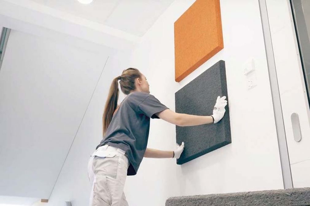 Foto; Mit seiner unregelmäßigen Faserstruktur, die auch unter der gespritzten Innenraumfarbe hervortritt, ist der Pflanzenfaser-Schallschutz ein Hingucker. Die Platten verleihen den Räumen neben der verbesserten Akustik eine natürliche Aura. 